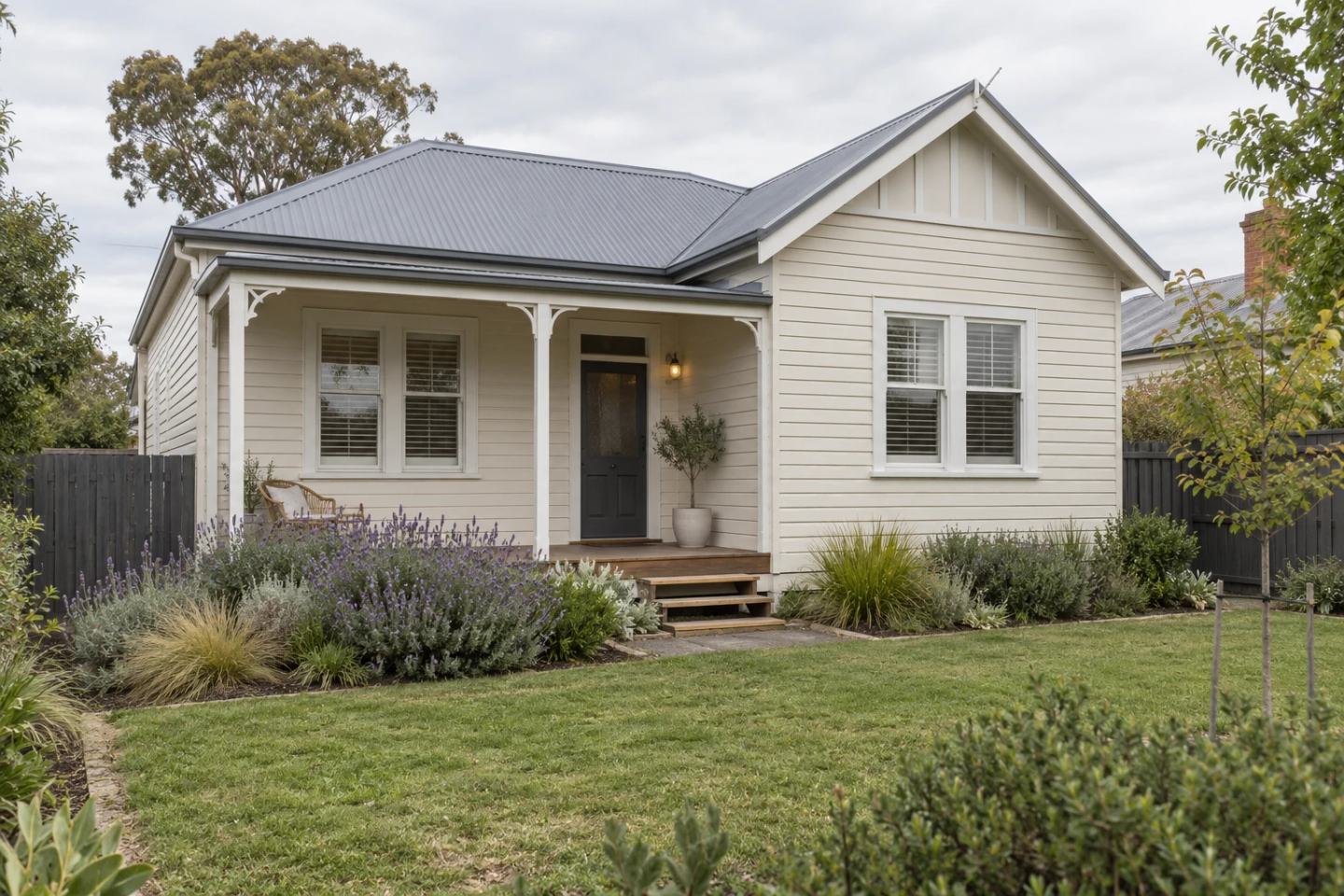 A maintained weatherboard home with a front verandah and garden